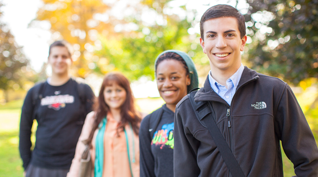 A group of La Roche students standing outside on a fall day